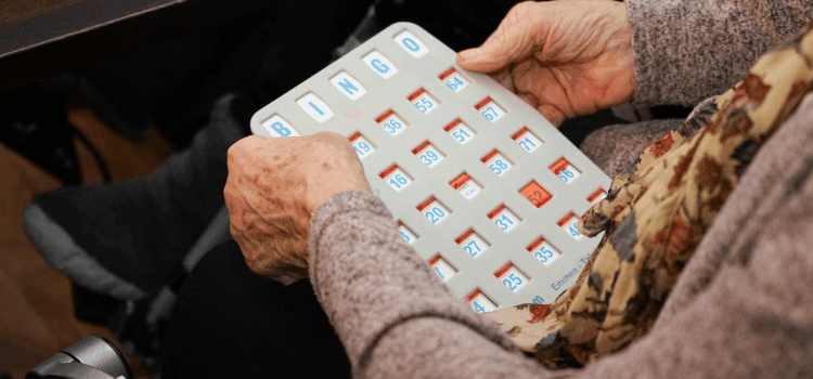 female hands holding the bingo board
