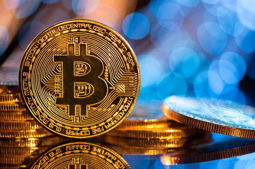 bitcoin gold coin with defocused abstract background.